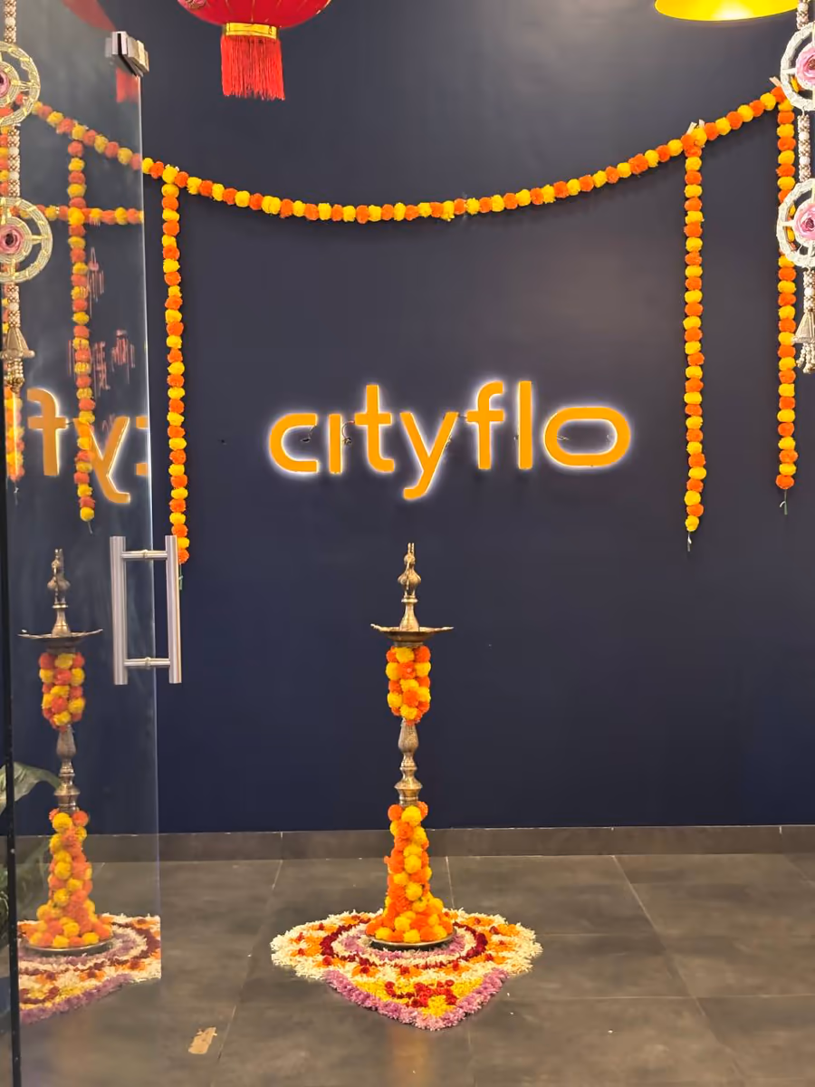 The Cityflo sign at the office entrance, dressed in marigolds for Diwali