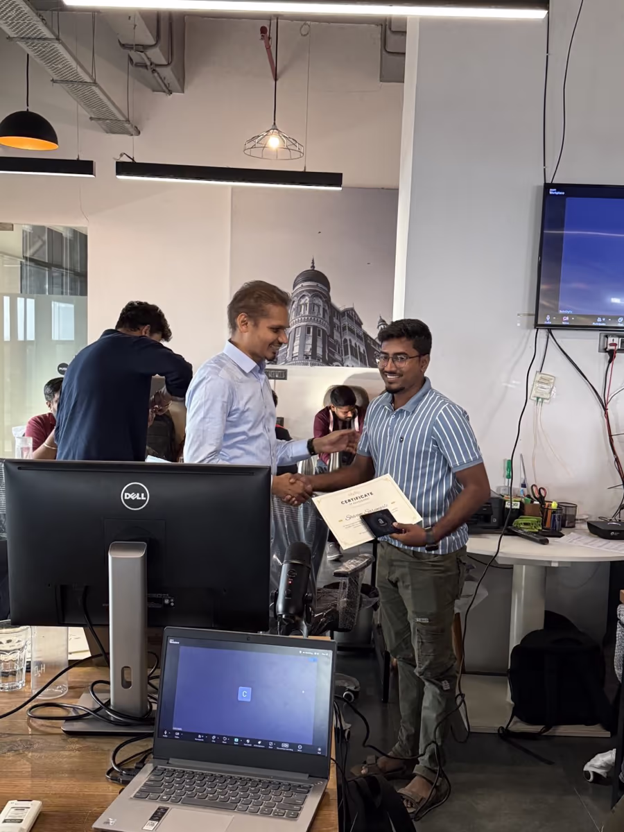 A teammate receiving a certificate on the office floor